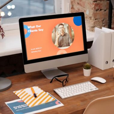 A modern home office setup with a desktop computer displaying a client testimonial on the screen.